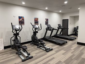 Large well-equipped fitness center with yoga area and free weights open 24 hours